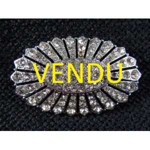 Old brooch decorated with rhinestones 