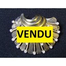 Old silver brooch with rhinestones